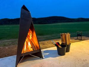 a woodburning stove sitting on top of a table at FLEXWORK tawa - Vacation STAY 75198v in Teshikaga