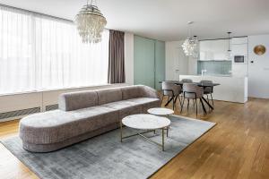 a living room with a couch and a table at Karlin Residence by TKC in Prague
