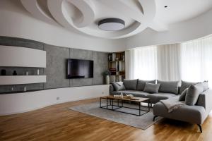 a living room with a couch and a table at Villa Vanja Belgrade in Belgrade