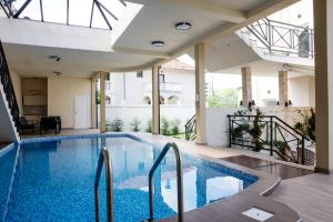 a large swimming pool in a building with a large ceiling at Villa Vanja Belgrade in Belgrade