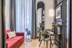 a living room with a red couch and a table at Residenza Piranesi Boutique Hotel in Rome