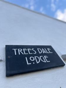 a sign on the side of a building with the words trees date lodge at Immaculate 2-Bed Lodge in Hayle in Hayle