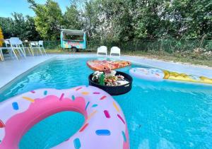 a pool with a table with a tray of food in the water at A'famosa Bungalow Villa 859 in Kampong Alor Gajah