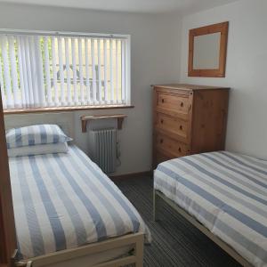 En eller flere senge i et værelse på Chynoweth Mews