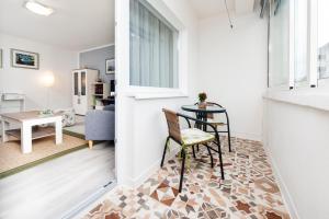 a living room with a table and a dining room at Apartman Oly in Rovinj