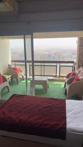 a bedroom with a bed and a balcony with chairs at Nile Star Suites & Apartments in Cairo