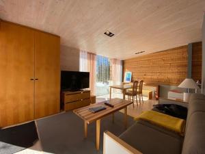 a living room with a couch and a table at Villa Tuikkula in Sotkamo