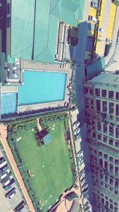 an aerial view of a building with a swimming pool at Downtown haven in Mohali