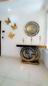 a bathroom with a mirror and butterflies on the wall at Downtown haven in Mohali