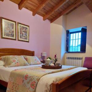 a bedroom with a bed with a tray on it at Casa Rural El Lagar del Abuelo en los Arribes del Duero, Badilla, Zamora in Zamora