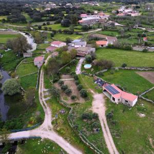 an aerial view of a village with a house and a road at El Lagar del Abuelo en los Arribes del Duero, Badilla, Zamora in Zamora