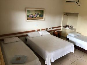Ένα ή περισσότερα κρεβάτια σε δωμάτιο στο Hotel Master Cuiabá