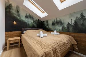 a bedroom with a bed with a painting on the wall at Apartamenty Nad Wisłą - z sauną i blisko centrum - Dream Apart in Ustroń
