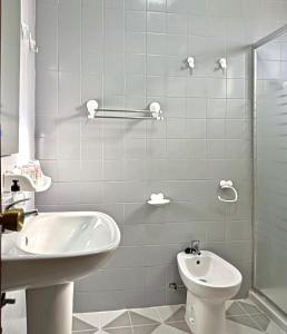 a white bathroom with a sink and a toilet at La Casa de Teror in Teror