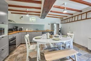a kitchen with a white table and chairs at Augustine Beach - Maison à 700 m de la plage in Courseulles-sur-Mer +7 photos