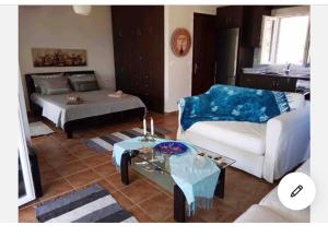 a living room with a couch and a table at Aphrodite studio in Póndi