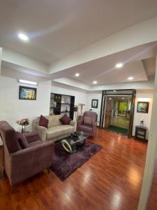 a living room with a couch and two chairs at Swayambhu Hotels & Apartments- Sitapaila in Kathmandu