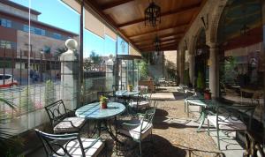 a patio with tables and chairs on a building at Hotel Maria Cristina in Toledo