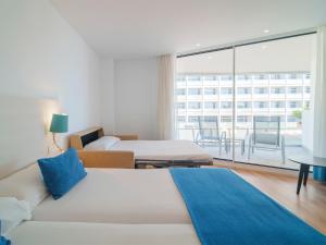 a hotel room with two beds and a large window at Spirit Hotel Benalmadena Beach in Benalmádena