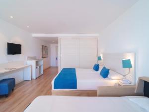 a hotel room with a bed and a desk at Spirit Hotel Benalmadena Beach in Benalmádena