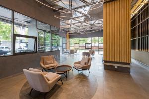 a lobby with chairs and a table and windows at Millerz Square Near MidValley by YourSuperhost in Kuala Lumpur +15 photos