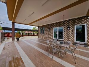 an empty patio with a table and chairs on it at The Blue Guest House, Parking, Aulong in Taiping
