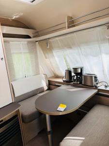 a small table in an rv with two coffee makers on it at Reisemobil Zentrum Berlin in Berlin