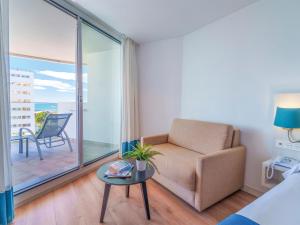 a living room with a couch and a table at Spirit Hotel Benalmadena Beach in Benalmádena