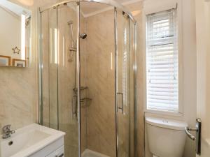a bathroom with a shower and a toilet and a sink at Shoreside Lodge in Bowness-on-Windermere +35 photos