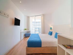 a bedroom with a large bed and a television at Spirit Hotel Benalmadena Beach in Benalmádena