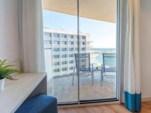 a room with a balcony with a view of a building at Spirit Hotel Benalmadena Beach in Benalmádena