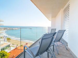 a balcony with chairs and a view of the beach at Spirit Hotel Benalmadena Beach in Benalmádena