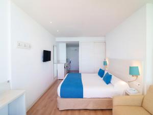 a bedroom with a large bed and a couch at Spirit Hotel Benalmadena Beach in Benalmádena