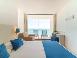 a bedroom with a bed and a view of the ocean at Spirit Hotel Benalmadena Beach in Benalmádena