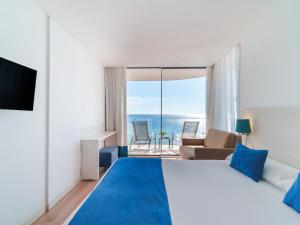a bedroom with a bed and a view of the ocean at Spirit Hotel Benalmadena Beach in Benalmádena