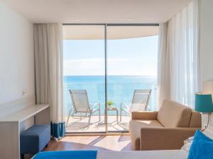 a living room with a couch and chairs at Spirit Hotel Benalmadena Beach in Benalmádena