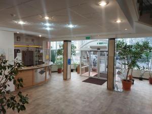 an empty lobby with plants in a building at Hostel Relaks in Olsztyn