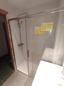 a shower stall in a bathroom with a sign on it at Apartamento ROQUETAS DE MAR MUY CERCA PLAYA in Roquetas de Mar +12 photos