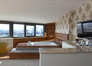 a large bathroom with a tub and a large window at Aram Otel Business & Luxury in Istanbul