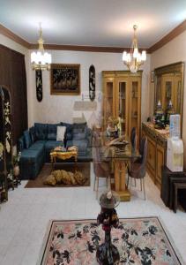 a living room with a blue couch and a table at فيلا رائعه في الساحل الشمالي مارينا 6 اطلاله بحر in El Alamein