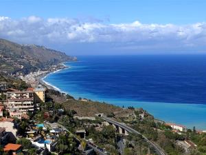 an aerial view of the ocean and a city at Villino rosso in Taormina