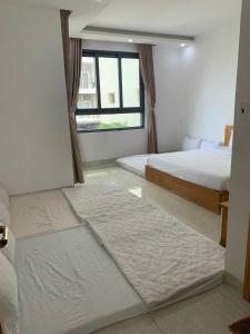 a bedroom with two beds and a window at Minh Phước Villa 12 Kim Ngân in Vung Tau