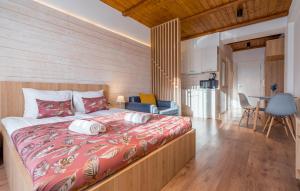 a bedroom with a large bed and a kitchen at New Gudauri Ski4Life in Gudauri