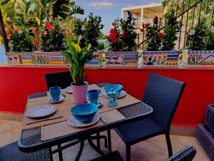 a table with blue cups and plates on it at Villino rosso in Taormina