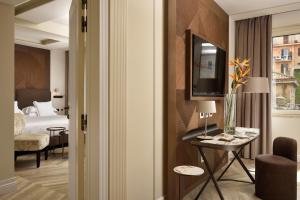 Uma cama ou camas num quarto em FH55 Grand Hotel Palatino