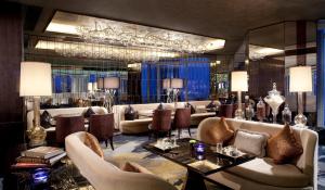 a hotel lobby with couches and a table and chairs at The Ritz-Carlton Hong Kong in Hong Kong