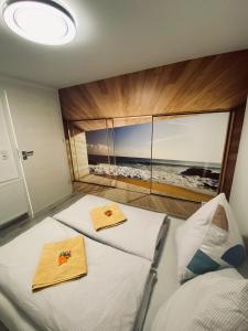 two beds in a room with a view of the ocean at Rhein Appartements in Rheinhausen