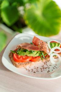 a sandwich on a white plate on a table at Spirit Hotel Benalmadena Beach in Benalmádena