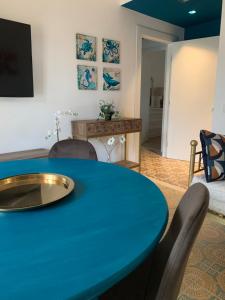 a living room with a blue table and chairs at A Casa Così B&b in Marzocca di Senigallia
