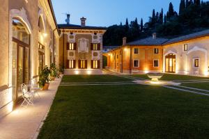 a courtyard of a building with a grass yard at Villa Padovani Relais de Charme - Adults Only in Pastrengo